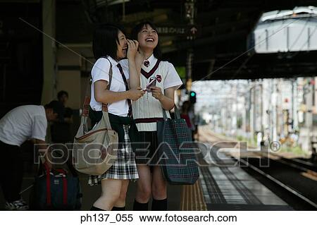 Two teenage girls standing at a train station View Large Photo Image Stock Photography - Two teenage girls standing at a train station. Fotosearch