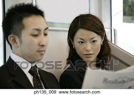 Young business executives reading the papers together View Large Photo Image Stock Photo - Young business executives reading the papers together. Fotosearch