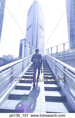 Young businessman climbing stairs View Large Photo Image Stock Photo - Young businessman climbing stairs. Fotosearch