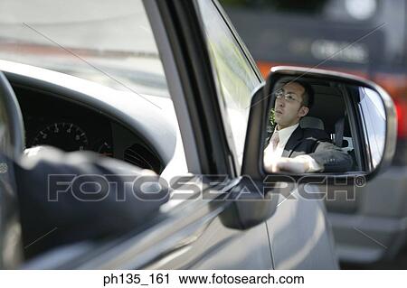 Young businessman sitting in his car View Large Photo Image Stock Image - Young businessman sitting in his car. Fotosearch