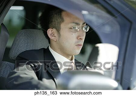 Young businessman sitting in his car View Large Photo Image Stock Image - Young businessman sitting in his car. Fotosearch