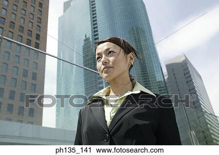 Stock Image - Young businesswoman looking ahead. Fotosearch