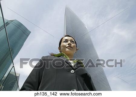 Stock Image - Young businesswoman looking ahead. Fotosearch