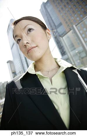 Stock Photo - Young businesswoman looking ahead. Fotosearch