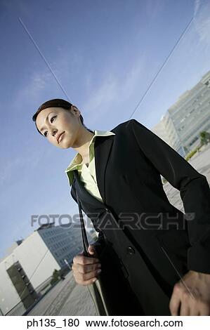 Young businesswoman standing with a shoulder bag View Large Photo Image Stock Image - Young businesswoman standing with a shoulder bag. Fotosearch