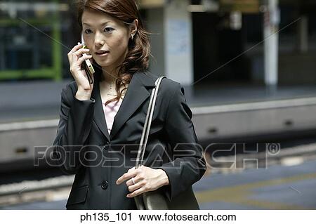 Young businesswoman talking on a mobile phone View Large Photo Image Stock Image - Young businesswoman talking on a mobile phone. Fotosearch