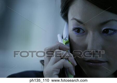 Young businesswoman talking on a mobile phone View Large Photo Image Stock Image - Young businesswoman talking on a mobile phone. Fotosearch