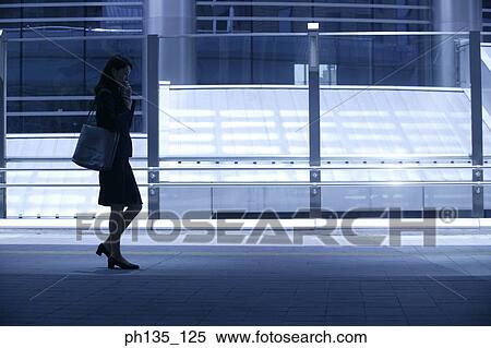 Young businesswoman talking on a mobile phone View Large Photo Image Stock Photography - Young businesswoman talking on a mobile phone. Fotosearch