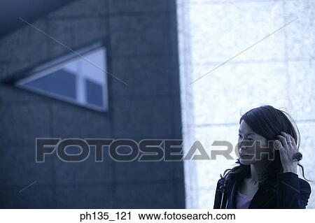 Young businesswoman touching her hair View Large Photo Image Stock Image - Young businesswoman touching her hair. Fotosearch