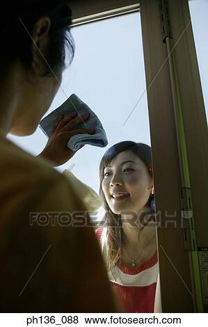 Stock Photo - Young couple cleaning windows. Fotosearch