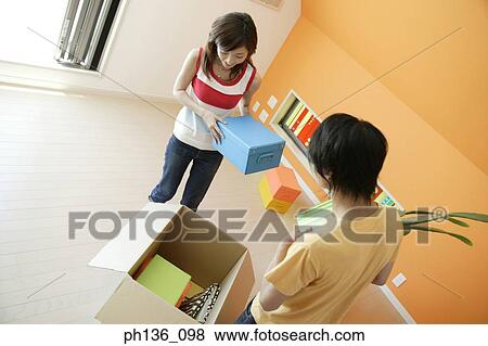 Young couple holding boxes View Large Photo Image Stock Photo - Young couple holding boxes. Fotosearch