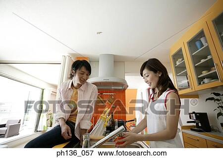 Stock Photo - Young couple in the kitchen. Fotosearch
