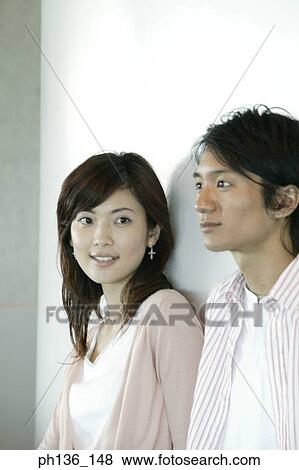 Stock Photo - Young couple Leaning against a wall. Fotosearch