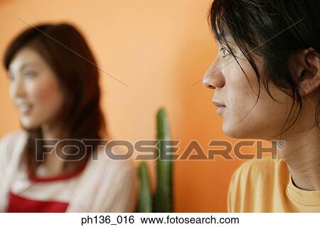 Stock Photograph - Young couple looking ahead. Fotosearch