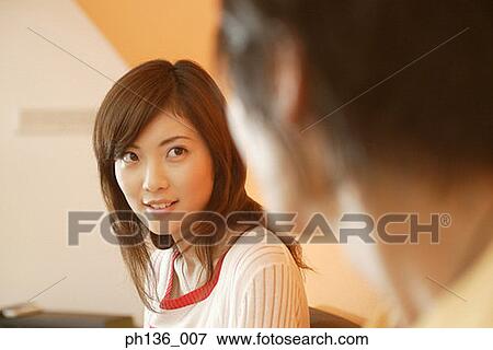 Stock Photo - Young couple looking at each other. Fotosearch