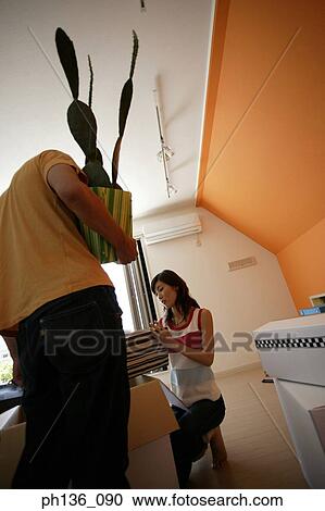 Young couple unpacking a box View Large Photo Image Stock Image - Young couple unpacking a box. Fotosearch