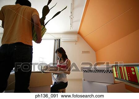 Young couple unpacking a box View Large Photo Image Stock Image - Young couple unpacking a box. Fotosearch