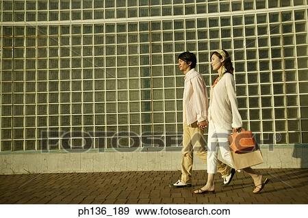 Stock Photo - Young couple walking. Fotosearch