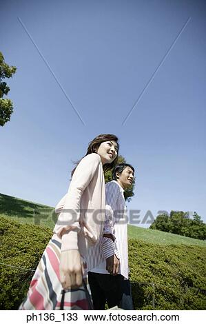 Stock Image - Young couple walking together. Fotosearch