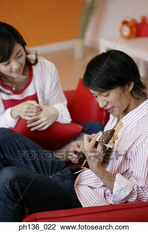 Young man playing a guitar and a woman sitting beside View Large Photo Image Stock Image - Young man playing a guitar and a woman sitting beside. Fotosearch