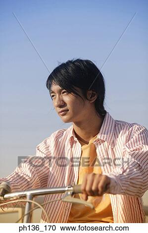 Stock Image - Young man Riding a bicycle. Fotosearch