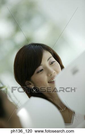 Stock Image - Young woman smiling. Fotosearch