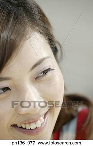 Young woman smiling View Large Photo Image Stock Photo - Young woman smiling. Fotosearch
