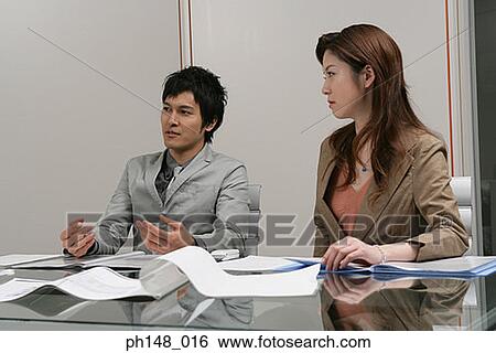 Businessman and a businesswoman in a meeting View Large Photo Image Stock Photograph - Businessman and a businesswoman in a meeting. Fotosearch