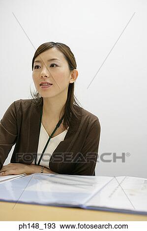 Businesswoman sitting in an office View Large Photo Image Stock Image - Businesswoman sitting in an office. Fotosearch
