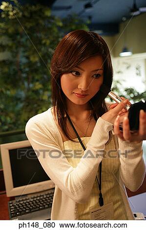 Close-up of a businesswoman applying blush on her face View Large Photo Image Stock Image - Close-up of a businesswoman applying blush on her face. Fotosearch