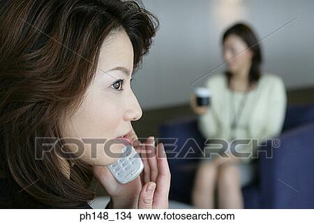 Picture - Close-up of a businesswoman using a mobile phone. Fotosearch
