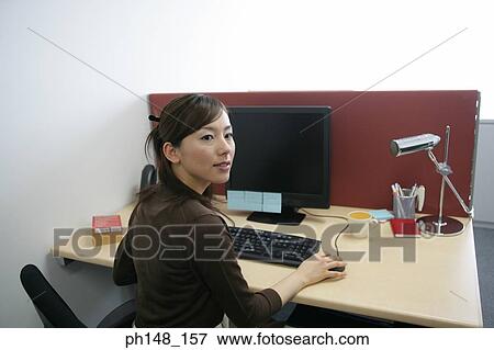 Close-up of a businesswoman using a computer View Large Photo Image Stock Photo - Close-up of a businesswoman using a computer. Fotosearch