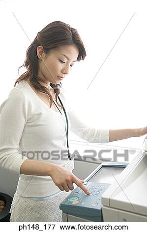 Close-up of a businesswoman using a photocopier View Large Photo Image Stock Photo - Close-up of a businesswoman using a photocopier. Fotosearch