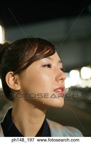 Close-up of a young woman crying View Large Photo Image Stock Photo - Close-up of a young woman crying. Fotosearch