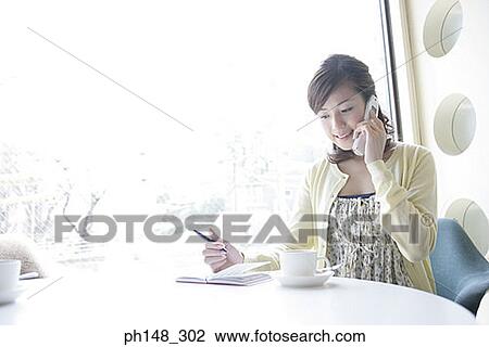 Stock Image - Close-up of a young woman talking on a mobile phone. Fotosearch