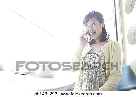 Stock Photo - Close-up of a young woman talking on a mobile phone. Fotosearch