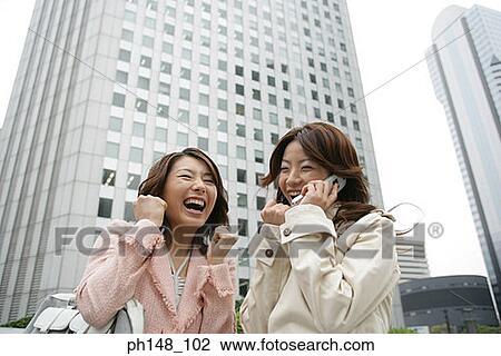 Stock Image - Close-up of a young woman using a mobile phone. Fotosearch