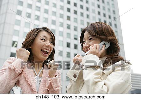 Close-up of a young woman using a mobile phone View Large Photo Image Stock Image - Close-up of a young woman using a mobile phone. Fotosearch