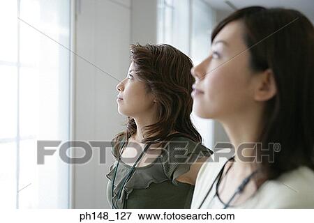 Close-up of two businesswomen looking up and thinking View Large Photo Image Stock Photo - Close-up of two businesswomen looking up and thinking. Fotosearch
