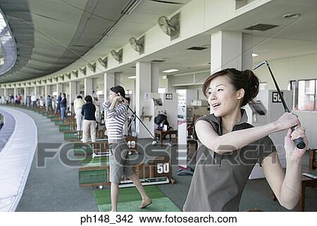 Close-up of two young women playing golf View Large Photo Image Stock Image - Close-up of two young women playing golf. Fotosearch