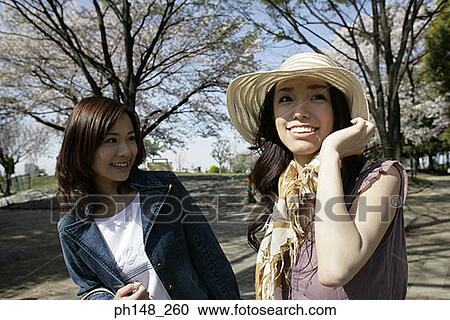 Close-up of two young women smiling View Large Photo Image Stock Image - Close-up of two young women smiling. Fotosearch