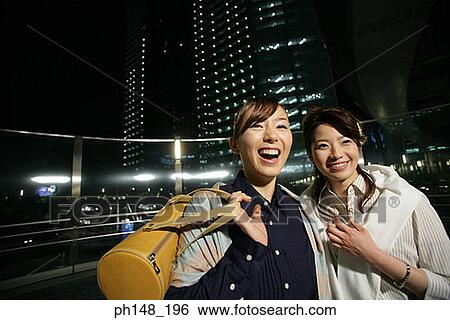 Stock Photograph - Close-up of two young women smiling. Fotosearch