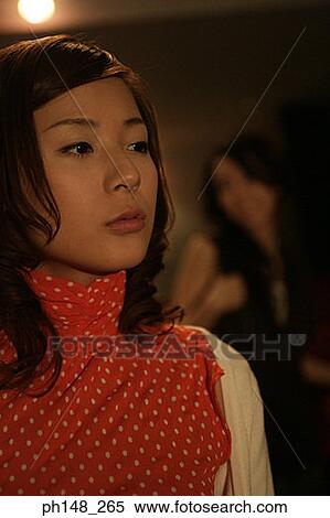 Close-up of two young women standing in a movie theater View Large Photo Image Stock Photography - Close-up of two young women standing in a movie theater. Fotosearch