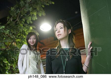 Low angle view of two businesswomen standing on a staircase View Large Photo Image Stock Photograph - Low angle view of two businesswomen standing on a staircase. Fotosearch