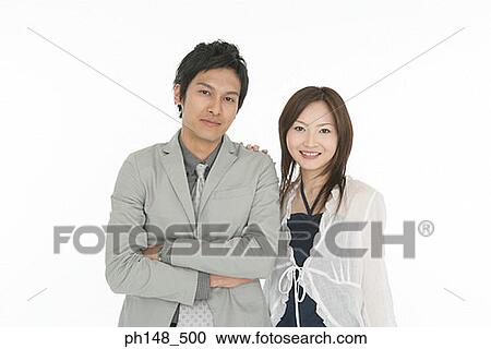 Stock Image - Portrait of a businessman and a businesswoman standing together. Fotosearch