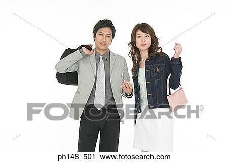 Portrait of a businessman and a businesswoman listening to an MP3 player View Large Photo Image Stock Image - Portrait of a businessman and a businesswoman listening to an MP3 player. Fotosearch
