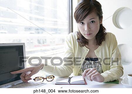 Portrait of a businesswoman pointing at a laptop View Large Photo Image Picture - Portrait of a businesswoman pointing at a laptop. Fotosearch