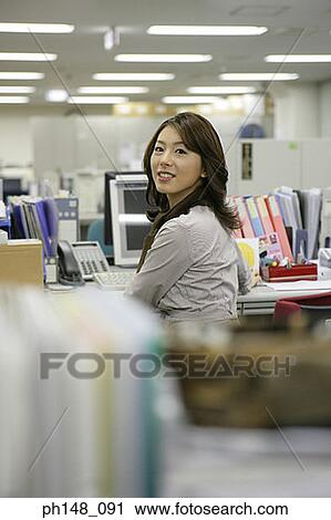 Portrait of a businesswoman sitting in the office and smiling View Large Photo Image Stock Image - Portrait of a businesswoman sitting in the office and smiling. Fotosearch