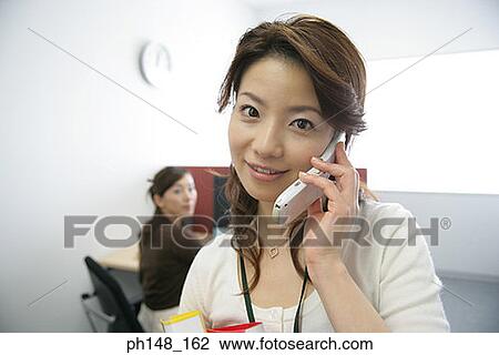 Portrait of a businesswoman using a mobile phone and looking cheerful View Large Photo Image Stock Image - Portrait of a businesswoman using a mobile phone and looking cheerful. Fotosearch