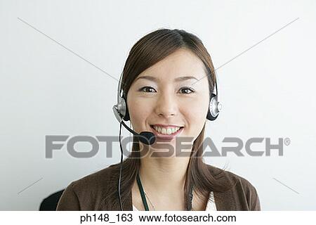 Portrait of a businesswoman wearing a headset and smiling View Large Photo Image Stock Image - Portrait of a businesswoman wearing a headset and smiling. Fotosearch